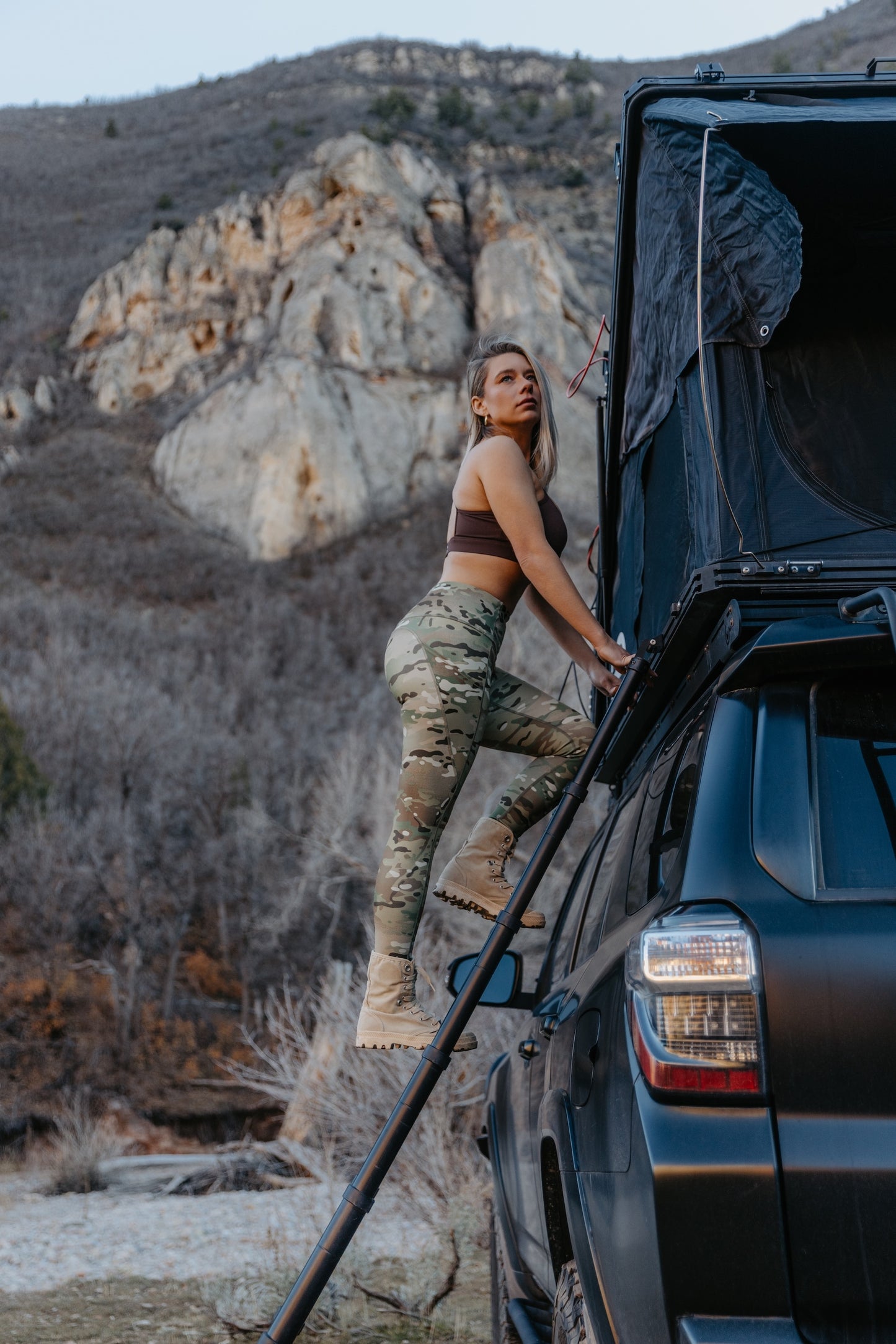 Women’s camo leggings in action during outdoor training climbing into vehicle showcasing flexibility and fit