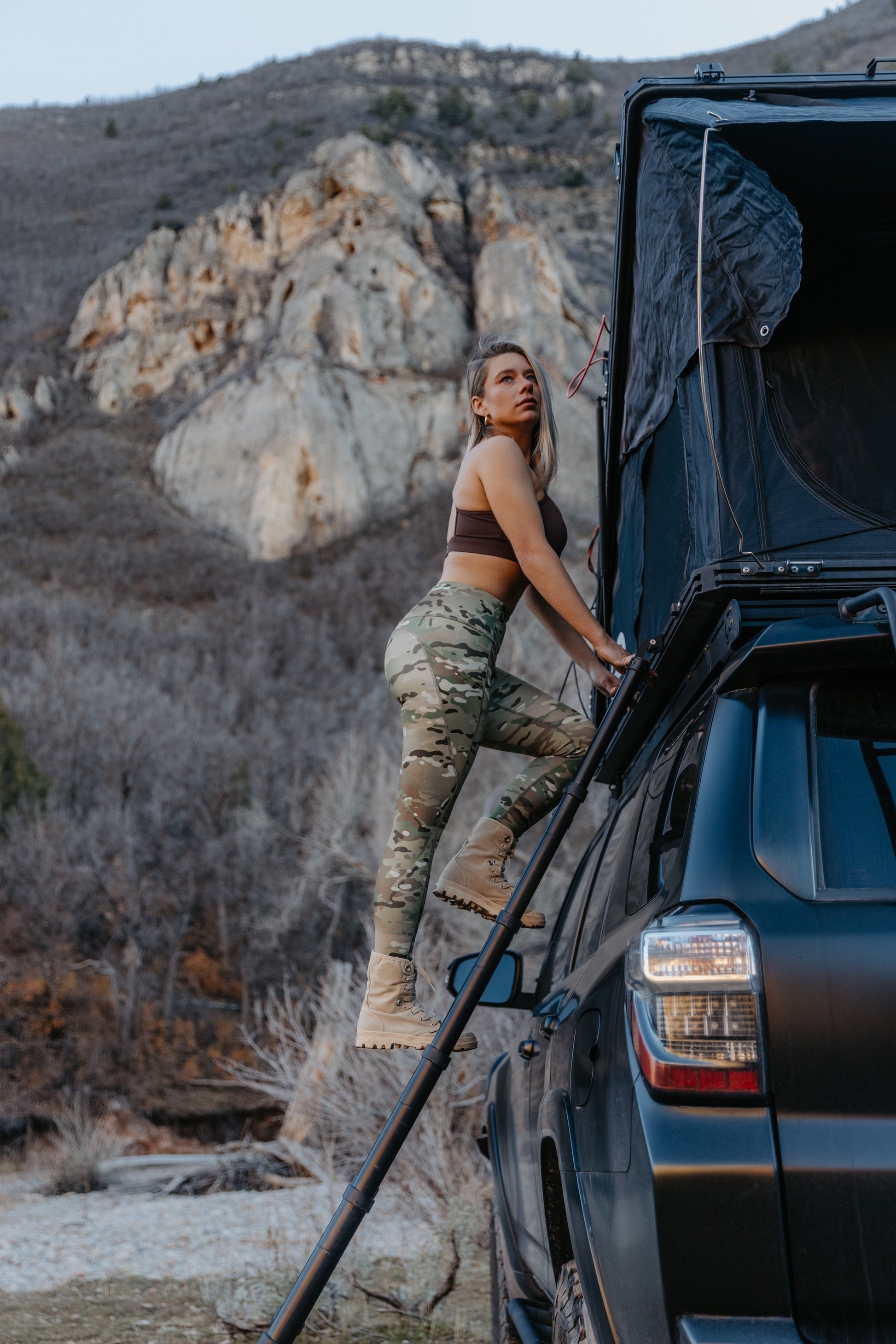 Women’s camo leggings in action during outdoor training climbing into vehicle showcasing flexibility and fit